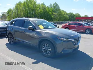 2021 Mazda CX-9 Touring z VIN JM3TCACY7M0503484, wystawiony jako IAAI lot #42013262 z przebiegiem 63 777 mil mil oraz . Historia ofert i sprzedaży dostępna na DreamBid. Obrazek 1.