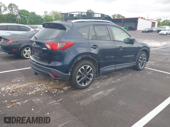 2016 Mazda CX-5 Grand Touring with VIN JM3KE2DYXG0890174, listed as a IAAI auction lot 42157884 with 141,873 mi miles. Bid and sale history available at carsss.com. Image 4.