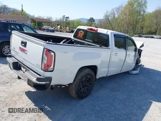 2019 GMC Canyon 4WD SLE z VIN 1GTG6CEN0K1353094, wystawiony jako IAAI lot #42065160 z przebiegiem 73 235 mil mil oraz . Historia ofert i sprzedaży dostępna na DreamBid. Obrazek 4.