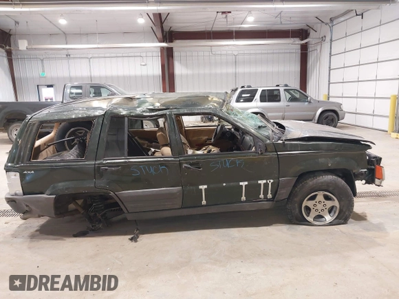 1997 Jeep Grand Cherokee Laredo z VIN 1J4GZ58YXVC729117, wystawiony jako IAAI lot #42244799 z przebiegiem Nie podano mil oraz . Historia ofert i sprzedaży dostępna na DreamBid. Obrazek 14.