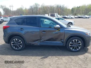 2016 Mazda CX-5 Grand Touring z VIN JM3KE4DY1G0893119, wystawiony jako IAAI lot #42049614 z przebiegiem 102 506 mil mil oraz . Historia ofert i sprzedaży dostępna na DreamBid. Obrazek 13.
