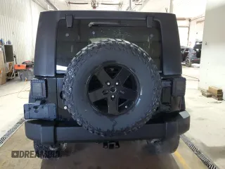 2009 Jeep Wrangler Unlimited Rubicon with VIN 1J8GA69179L756441, listed as a Copart auction lot 52111435 with 157,818 mi miles and Salvage title. Bid and sale history available at DreamBid. Image 6.