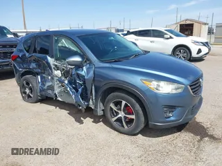 2016 Mazda CX-5 Touring z VIN JM3KE2CY9G0828671, wystawiony jako IAAI lot #41943474 z przebiegiem 126 364 mil mil oraz . Historia ofert i sprzedaży dostępna na DreamBid. Obrazek 1.
