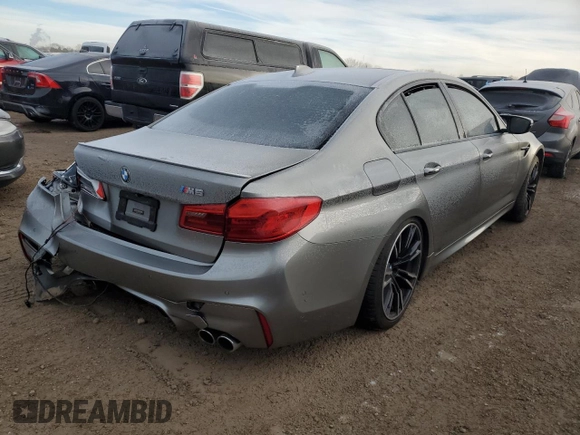 2018 BMW M5 z VIN WBSJF0C56JB282184, wystawiony jako Copart lot #87480414 z przebiegiem Nie podano mil oraz Szkody całkowita. Historia ofert i sprzedaży dostępna na DreamBid. Obrazek 3.