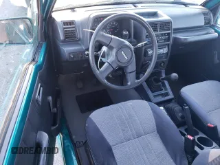 1995 Suzuki Sidekick z VIN 2S3TA02C3S6414337, wystawiony jako Copart lot #86304134 z przebiegiem 104 889 mil mil oraz Szkody całkowita. Historia ofert i sprzedaży dostępna na DreamBid. Obrazek 8.