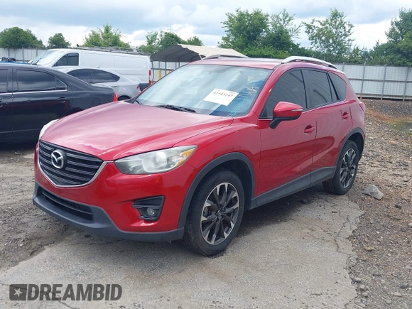 2016 Mazda CX-5 Grand Touring z VIN JM3KE2DY6G0693678, wystawiony jako IAAI lot #42443247 z przebiegiem 127 620 mil mil oraz . Historia ofert i sprzedaży dostępna na DreamBid. Obrazek 2.