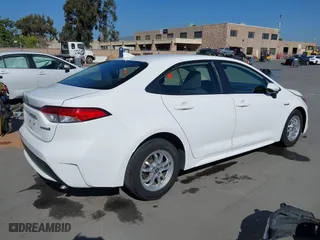 2021 Toyota Corolla Hybrid LE with VIN JTDEAMDE6MJ032371, listed as a IAAI auction lot 42086942 with 68,335 mi miles. Bid and sale history available at carsss.com. Image 4.