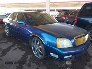 2003 Cadillac DeVille DTS z VIN 1G6KF57943U114611, wystawiony jako IAAI lot #41661350 z przebiegiem 160 762 mil mil oraz . Historia ofert i sprzedaży dostępna na DreamBid. Obrazek 1.