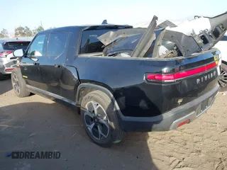 2023 Rivian R1T Adventure with VIN 7FCTGAAAXPN022097, listed as a IAAI auction lot 41235625 with 11,210 mi miles. Bid and sale history available at carsss.com. Image 3.