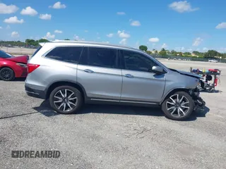 2021 Honda Pilot Touring 8-Passenger with VIN 5FNYF5H99MB041638, listed as a IAAI auction lot 42112915 with 33,230 mi miles and . Bid and sale history available at DreamBid. Image 13.