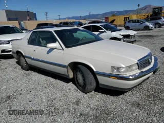 1994 Cadillac Eldorado ESC z VIN 1G6EL12Y6RU619510, wystawiony jako Copart lot #51524645 z przebiegiem 139 223 mil mil oraz Szkody całkowita. Historia ofert i sprzedaży dostępna na DreamBid. Obrazek 4.
