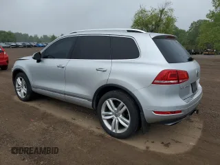 2014 Volkswagen Touareg Sport с VIN WVGEF9BP0ED014429, выставлен на аукционе Copart как лот 58692875 с пробегом 157 417 миль миль и Списание • Salvage title. История ставок и продаж доступна на DreamBid. Изображение 2.