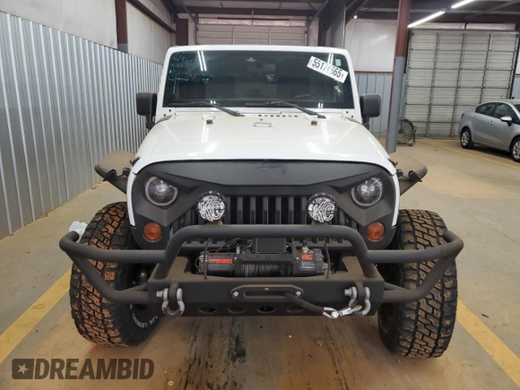 2012 Jeep Wrangler Unlimited Sport z VIN 1C4BJWDG4CL140250, wystawiony jako Copart lot #55174665 z przebiegiem 91 285 mil mil oraz Szkoda całkowita • Salvage title. Historia ofert i sprzedaży dostępna na DreamBid. Obrazek 5.
