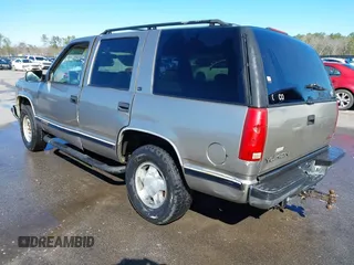 1998 GMC Yukon with VIN 1GKEK13R4WJ725608, listed as a IAAI auction lot 41596559 with 323,141 mi miles. Bid and sale history available at carsss.com. Image 3.