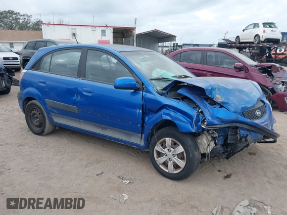 2009 Kia Rio LX with VIN KNADE243296494243, listed as a IAAI auction lot 41307888 with 133,487 mi miles. Bid and sale history available at carsss.com. Image 1.