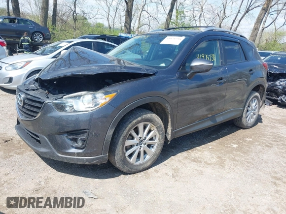 2016 Mazda CX-5 Touring with VIN JM3KE4CYXG0620990, listed as a IAAI auction lot 41978738 with 91,237 mi miles and . Bid and sale history available at carsss.com. Image 2.