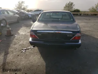 1999 Jaguar XJ with VIN SAJHD1048XC867723, listed as a Copart auction lot 76745444 with 170,999 mi miles and Salvage Title. Bid and sale history available at carsss.com. Image 6.