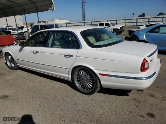 2005 Jaguar XJ with VIN SAJWA79C35SG48607, listed as a Copart auction lot 77132444 with 159,051 mi miles and Salvage Title. Bid and sale history available at carsss.com. Image 2.