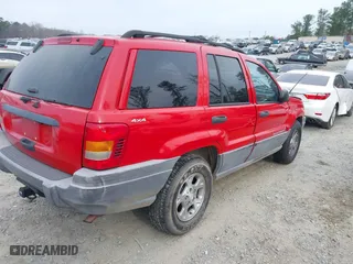 1999 Jeep Grand Cherokee Laredo with VIN 1J4GW58S0XC519908, listed as a IAAI auction lot 41789905 with 221,064 mi miles. Bid and sale history available at carsss.com. Image 4.