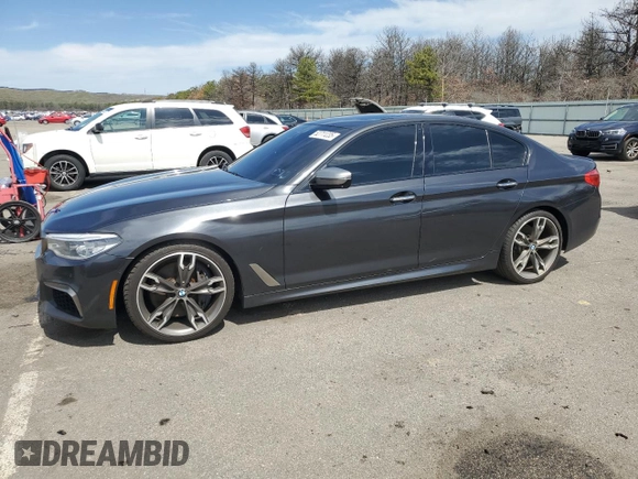 2018 BMW 5 Series M550i xDrive with VIN WBAJB9C57JB286734, listed as a Copart auction lot 52711235 with 127,450 mi miles and Salvage title. Bid and sale history available at DreamBid. Image 1.