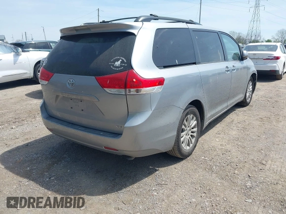 2014 Toyota Sienna XLE with VIN 5TDYK3DC9ES413283, listed as a IAAI auction lot 42091379 with 184,506 mi miles and . Bid and sale history available at DreamBid. Image 4.