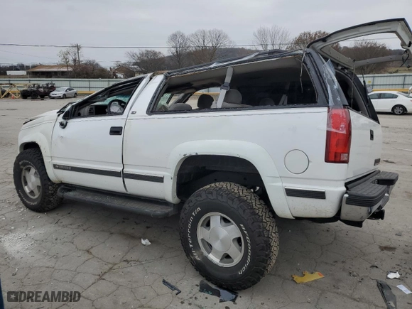 1999 Chevrolet Tahoe with VIN 3GNEK18R7XG230110, listed as a Copart auction lot 82932774 with 148,055 mi miles and Salvage Title. Bid and sale history available at carsss.com. Image 2.