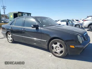 2000 Mercedes-Benz E-Class with VIN WDBJF70JXYB091085, listed as a Copart auction lot 77136484 with 185,429 mi miles and Salvage Title. Bid and sale history available at carsss.com. Image 4.