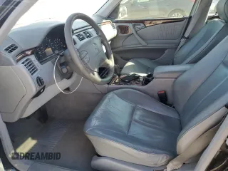 2000 Mercedes-Benz E-Class with VIN WDBJF70JXYB091085, listed as a Copart auction lot 77136484 with 185,429 mi miles and Salvage Title. Bid and sale history available at carsss.com. Image 7.