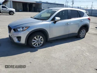 2016 Mazda CX-5 Touring z VIN JM3KE2CY4G0906967, wystawiony jako Copart lot #50243205 z przebiegiem 122 060 mil mil oraz Szkoda całkowita • Salvage title. Historia ofert i sprzedaży dostępna na DreamBid. Obrazek 1.