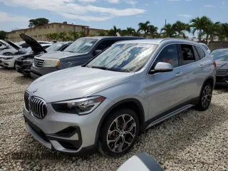 2021 BMW X1 sDrive28i with VIN WBXJG7C04M5S29295, listed as a Copart auction lot 48922203 with 14,214 mi miles. Bid and sale history available at carsss.com. Image 1.