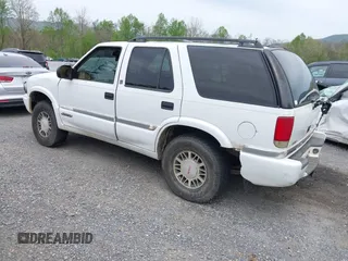 1999 GMC Jimmy SLE with VIN 1GKDT13WXX2521082, listed as a IAAI auction lot 42079903 with 160,055 mi miles. Bid and sale history available at carsss.com. Image 3.