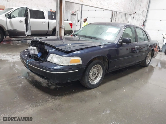 2000 Ford Crown Victoria with VIN 2FAFP73W1YX129365, listed as a IAAI auction lot 41865917 with 102,957 mi miles. Bid and sale history available at carsss.com. Image 2.