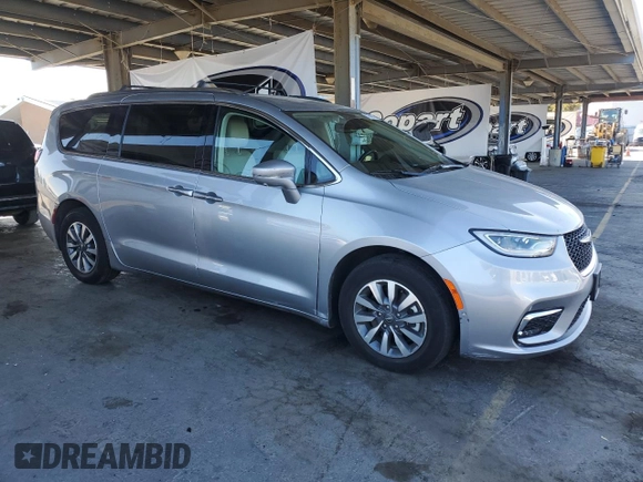 2021 Chrysler Pacifica Hybrid Touring L with VIN 2C4RC1L7XMR593911, listed as a Copart auction lot 57842415 with 74,910 mi miles and Salvage title. Bid and sale history available at DreamBid. Image 4.