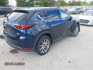 2019 Mazda CX-5 Grand Touring with VIN JM3KFBDM2K0603400, listed as a IAAI auction lot 42051135 with 59,448 mi miles and . Bid and sale history available at DreamBid. Image 4.