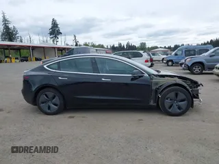 2019 Tesla Model 3 Mid Range with VIN 5YJ3E1EA6KF415656, listed as a IAAI auction lot 42140763 with 71,408 mi miles and . Bid and sale history available at carsss.com. Image 14.