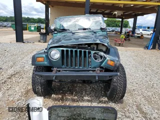 1999 Jeep Wrangler Sport with VIN 1J4FY19S0XP402688, listed as a Copart auction lot 58968125 with 211,910 mi miles and Salvage title. Bid and sale history available at DreamBid. Image 5.
