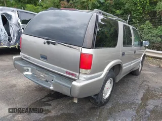 1999 GMC Jimmy SLE z VIN 1GKCS13W0X2512048, wystawiony jako IAAI lot #42364175 z przebiegiem 195 301 mil mil oraz . Historia ofert i sprzedaży dostępna na DreamBid. Obrazek 4.