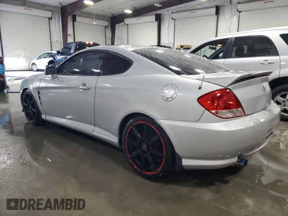 2006 Hyundai Tiburon GT z VIN KMHHN65F96U203924, wystawiony jako Copart lot #43624185 z przebiegiem 120 403 mil mil oraz Szkoda całkowita • Salvage title. Historia ofert i sprzedaży dostępna na DreamBid. Obrazek 2.