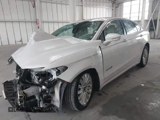 2013 Ford Fusion SE Hybrid with VIN 3FA6P0LU8DR357054, listed as a IAAI auction lot 42372168 with 143,979 mi miles and . Bid and sale history available at DreamBid. Image 2.