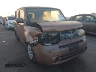 2011 Nissan Cube S z VIN JN8AZ2KR2BT200529, wystawiony jako IAAI lot #41273648 z przebiegiem 97 398 mil mil oraz . Historia ofert i sprzedaży dostępna na DreamBid. Obrazek 1.