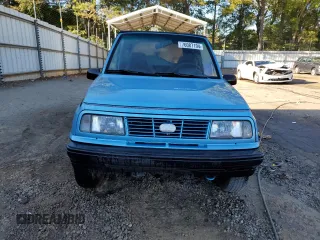 1995 Geo Tracker z VIN 2CNBE18U4S6948656, wystawiony jako Copart lot #76087194 z przebiegiem 163 080 mil mil oraz Szkody całkowita. Historia ofert i sprzedaży dostępna na DreamBid. Obrazek 5.