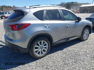 2014 Mazda CX-5 Grand Touring with VIN JM3KE4DY3E0368169, listed as a IAAI auction lot 41857976 with 127,853 mi miles. Bid and sale history available at carsss.com. Image 4.