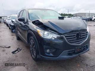 2016 Mazda CX-5 Grand Touring z VIN JM3KE4DY9G0605489, wystawiony jako IAAI lot #42085160 z przebiegiem 160 338 mil mil oraz . Historia ofert i sprzedaży dostępna na DreamBid. Obrazek 1.
