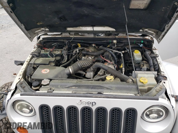 2007 Jeep Wrangler Unlimited Sahara с VIN 1J4GA591X7L158014, выставлен на аукционе Copart как лот 55201105 с пробегом 162 797 миль миль и Списание • Salvage title. История ставок и продаж доступна на DreamBid. Изображение 11.