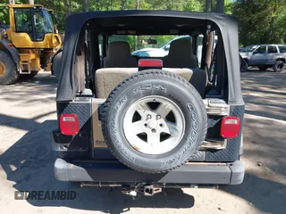 2003 Jeep Wrangler Sport z VIN 1J4FA49S13P313180, wystawiony jako IAAI lot #42349673 z przebiegiem 141 073 mil mil oraz . Historia ofert i sprzedaży dostępna na DreamBid. Obrazek 16.