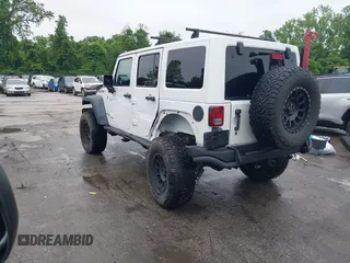 2014 Jeep Wrangler Unlimited Rubicon with VIN 1C4HJWFG4EL104827, listed as a IAAI auction lot 42236622 with 90,935 mi miles and . Bid and sale history available at DreamBid. Image 3.