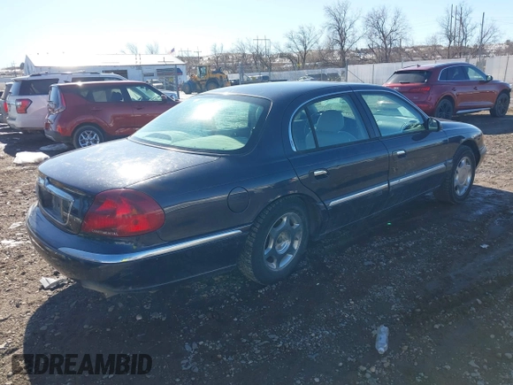 1999 Lincoln Continental with VIN 1LNHM97V8XY700644, listed as a IAAI auction lot 41641082 with 142,527 mi miles. Bid and sale history available at carsss.com. Image 4.