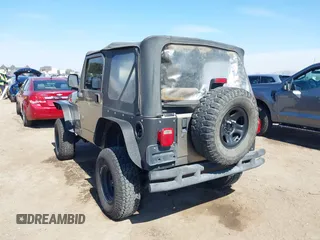 2005 Jeep Wrangler Sport with VIN 1J4FA49S65P342497, listed as a IAAI auction lot 41674606 with 123,457 mi miles. Bid and sale history available at carsss.com. Image 3.