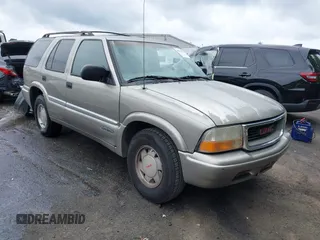 1999 GMC Jimmy SLE z VIN 1GKCS13W0X2512048, wystawiony jako IAAI lot #42364175 z przebiegiem 195 301 mil mil oraz . Historia ofert i sprzedaży dostępna na DreamBid. Obrazek 1.