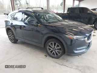 2018 Mazda CX-5 Grand Touring with VIN JM3KFBDM4J0302870, listed as a IAAI auction lot 41934217 with 57,151 mi miles. Bid and sale history available at carsss.com. Image 1.